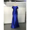 Stunning Royal Blue Stretch Satin off-the-shoulder mermaid gown with structured corset bodice, pleated details, and high slit on a dress form, showcasing luxurious sheen and elegant silhouette.