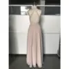 Detailed back view of the Nicolette Chiffon A-Line Gown highlighting the elegant criss-cross halter straps, open back design, concealed zipper closure at the waist, and the full flowy pleated chiffon skirt in luxurious mocha.