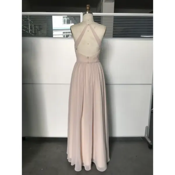 Detailed back view of the Nicolette Chiffon A-Line Gown highlighting the elegant criss-cross halter straps, open back design, concealed zipper closure at the waist, and the full flowy pleated chiffon skirt in luxurious mocha.