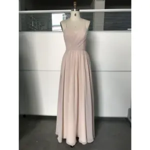 Front view of the Nicolette Chiffon A-Line Gown in soft mocha featuring a delicate sweetheart neckline with crossover draped bodice, thin spaghetti straps, natural waistband, and flowing pleated A-line skirt with subtle high slit detail.