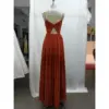Detailed back view of Camille in Paprika Chiffon A-Line Dress highlighting the dramatic open back with signature twist detail, delicate criss-cross spaghetti straps, and softly gathered waist leading into the flowing pleated skirt.