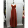 Front view of Camille Chiffon A-Line Dress in Paprika featuring a flattering twist-front bodice, delicate spaghetti straps, and flowing A-line skirt with soft pleats that create elegant movement.