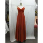 Front view of Camille Chiffon A-Line Dress in Paprika featuring a flattering twist-front bodice, delicate spaghetti straps, and flowing A-line skirt with soft pleats that create elegant movement.