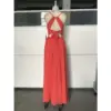 Back view of the Isolde Burnt Orange chiffon dress featuring intricate criss-cross straps, open back design with elegant bow detail at the waist, and flowing skirt with high slit for graceful movement.