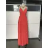 Elegant woman wearing a flowing Burnt Orange chiffon maxi dress with deep V-neckline and subtle high slit, showcasing lightweight fabric with graceful movement and sophisticated old money appeal.