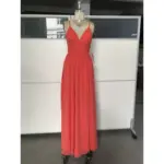 Elegant woman wearing a flowing Burnt Orange chiffon maxi dress with deep V-neckline and subtle high slit, showcasing lightweight fabric with graceful movement and sophisticated old money appeal.