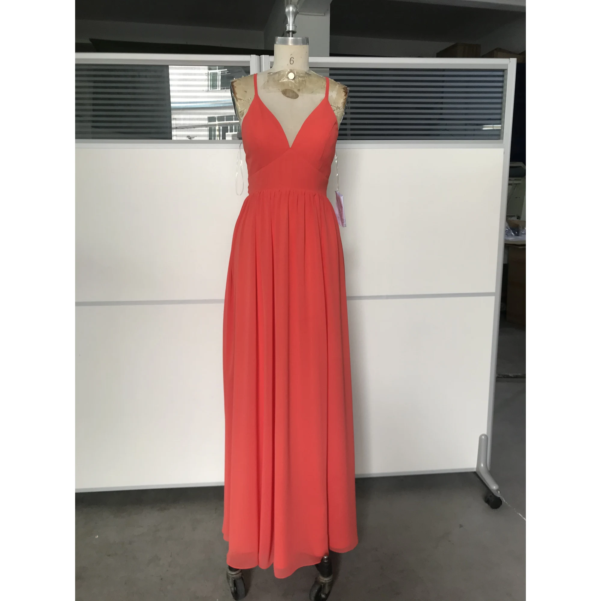 Elegant woman wearing a flowing Burnt Orange chiffon maxi dress with deep V-neckline and subtle high slit, showcasing lightweight fabric with graceful movement and sophisticated old money appeal.