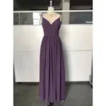 Elegant mauve chiffon dress with a deep V-neckline, delicate spaghetti straps, and intricate pleated bodice and skirt that cascades gracefully to the floor, highlighting its luxurious flow and subtle high slit detail.