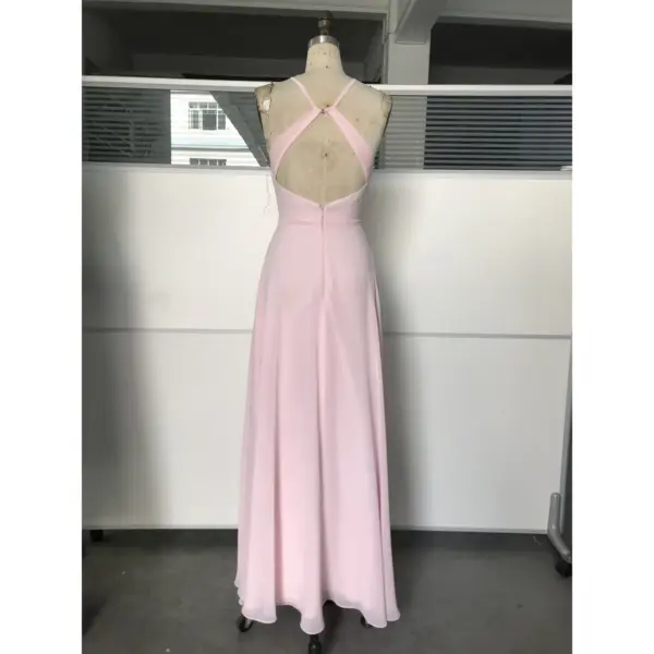 Back view of Pale Pink Chiffon Slit Dress showing open back with crisscross halter straps, concealed zipper closure and graceful flowing skirt with subtle side slit detail