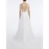 Elegant back view of the Ramona Ivory bridal gown showcasing a dramatic V-back with delicate lace detailing, corset closure and cascading embroidered tulle layers that flow into a chapel train for timeless bridal majesty.