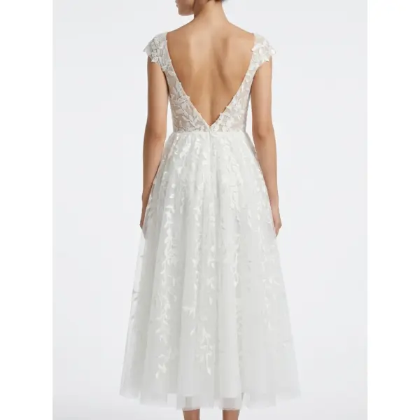Elegant back view of the Sarah Ivory tulle bridal dress showcasing a deep V-back with intricate floral embroidery and cascading layered tulle skirt perfect for wedding ceremonies