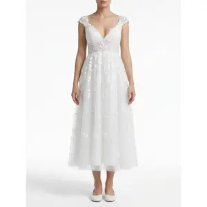 Sarah in stunning Ivory embroidered tulle tea length bridal gown with delicate floral lace appliques, romantic V-neckline and flowing A-line silhouette that captures ethereal romance and bridal glow