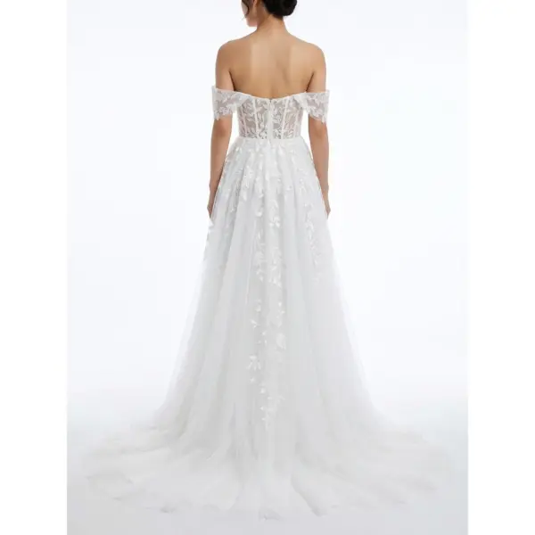Back view of the Vanessa Ivory tulle bridal ball gown showcasing an open back with intricate floral embroidery, corset-style lacing, and a dramatic flowing chapel train with layered tulle and horsehair hemline.
