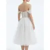 Back view of the Marie Ivory tulle ball gown showcasing intricate embroidered lace appliques across the sheer corset-style bodice, off-the-shoulder cap sleeves, natural waist, and voluminous tiered tulle skirt with soft movement.