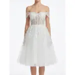 Front view of the Marie Ivory bridal gown featuring delicate embroidered leaf motifs on luxurious tulle fabric, romantic off-the-shoulder sweetheart neckline with illusion tulle straps, and a full layered tulle skirt that creates ethereal bridal romance.