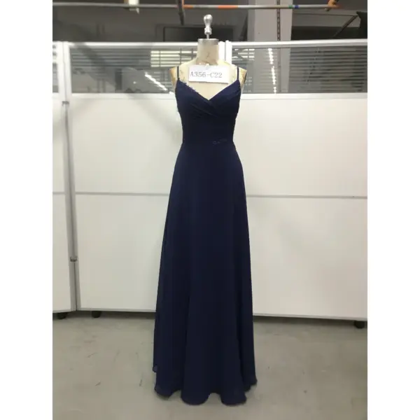 Elegant Evelina in rich Navy Chiffon with a flattering V-neckline, delicate lace appliqué at the bodice and waist, and soft ruched detailing that creates a timeless, flowing A-line silhouette.