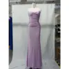 Front view of the Angie Lilac Ruched Jersey Sheath Gown featuring a strapless sweetheart neckline, intricate ruching throughout the bodice and hips, and a sleek column silhouette in luxurious lilac stretch jersey fabric.