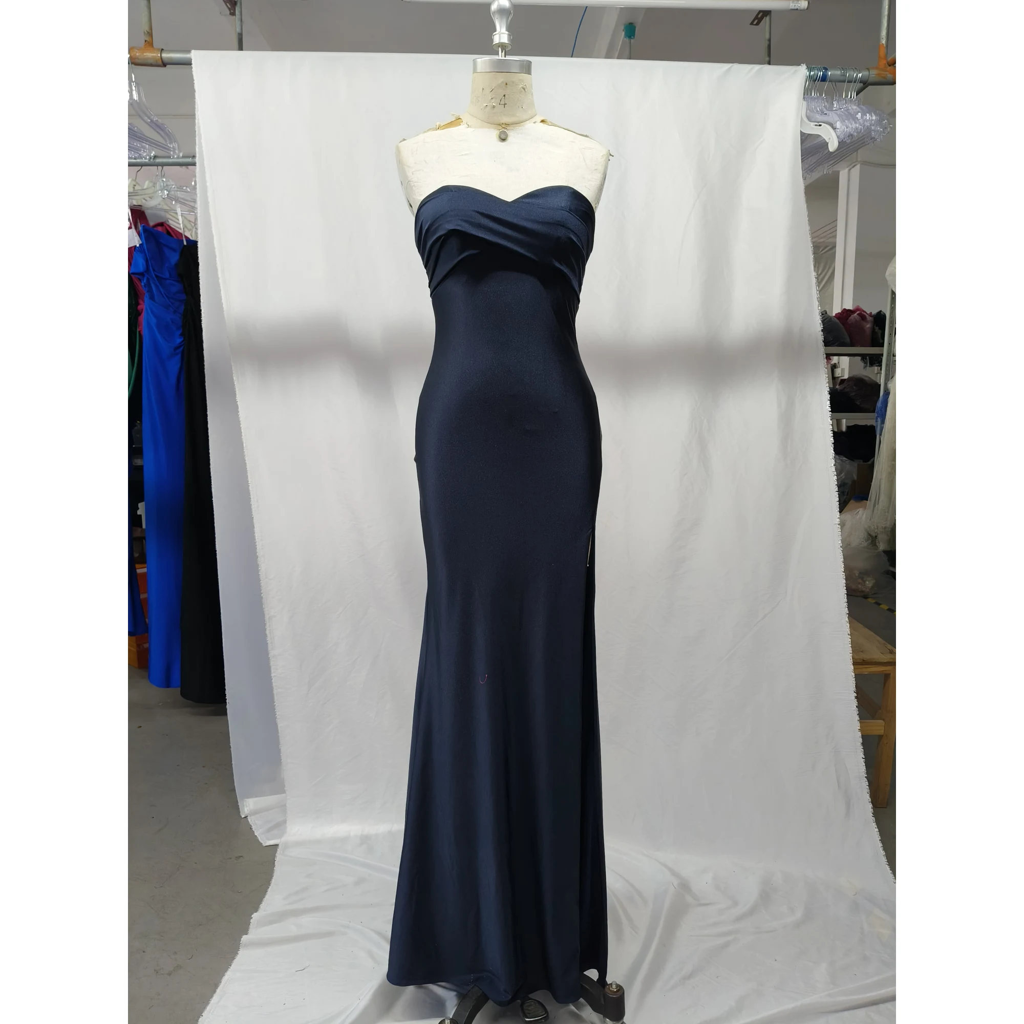 Front view of the Danielle Navy Jersey Strapless Mermaid Gown featuring a sleek strapless sweetheart neckline, fluid jersey fabric that hugs the figure, and a subtle high slit for elegant movement.