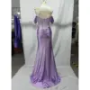 Back view of the Natasha Lilac Stretch Satin Mermaid Gown showcasing the sheer illusion corset back with vertical beaded detailing, central zipper closure, ruched waist, and sweeping floor-length stretch satin skirt with dramatic drape.