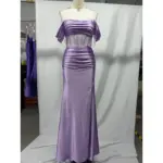 Front view of the Natasha Lilac Stretch Satin Mermaid Gown featuring an off-the-shoulder draped bodice with short flutter sleeves, a sheer corset midsection with vertical beaded straps, ruched natural waist, and a curve-hugging floor-length skirt with a high slit, all in luxurious stretch satin.