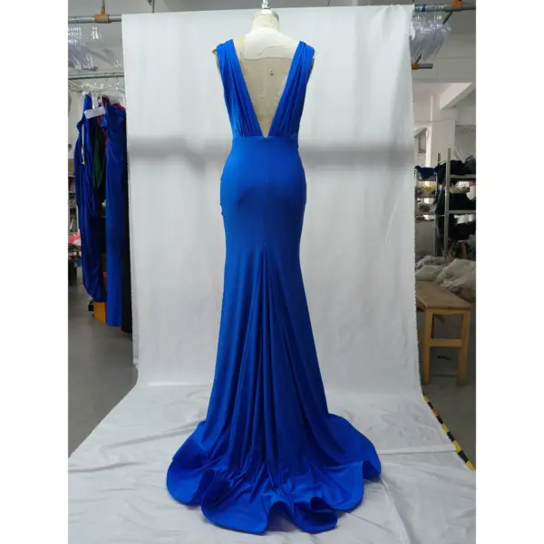 Back view of the Rachel Royal Blue jersey mermaid gown showcasing a dramatic deep V-back, smooth silhouette and luxurious draped train with soft folds in vibrant royal blue fabric.