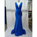 Stunning Rachel Royal Blue jersey mermaid gown featuring a deep plunging V-neckline, intricate draped bodice and cascading skirt that hugs the figure before flaring at the hem in rich, vibrant royal blue.