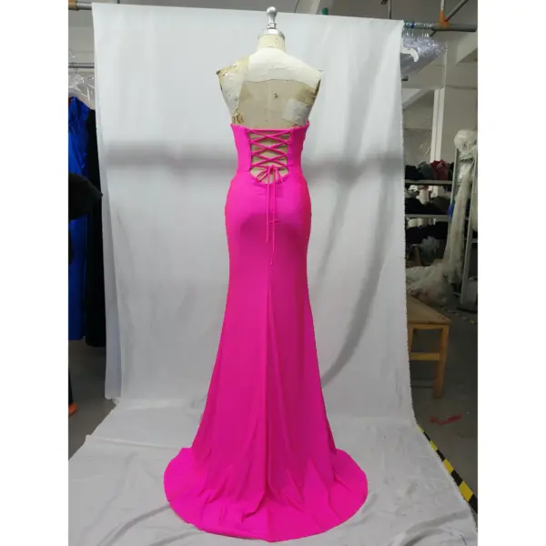 Back view of the Antonina fuchsia jersey mermaid gown featuring an intricate lace-up corset back, smooth stretch fabric, and a dramatic floor-length silhouette with a subtle train effect.