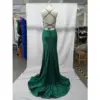 Back view of the Louise teal jersey mermaid gown showcasing intricate crisscross strap detailing, open back design with tie closure, fitted through the hips with a central zipper and flowing dramatic train.