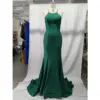Stunning teal jersey mermaid gown on a mannequin featuring a sleek halter neckline with thin spaghetti straps, figure-hugging silhouette that flares into a dramatic sweep train, luxurious fabric with beautiful drape and subtle sheen.