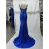 Back view of the Seraphina Royal Blue mermaid dress showcasing the dramatic lace-up corset back, open design, and sweeping train in lustrous stretch satin with lace applique details.