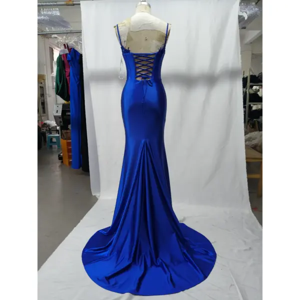 Back view of the Seraphina Royal Blue mermaid dress showcasing the dramatic lace-up corset back, open design, and sweeping train in lustrous stretch satin with lace applique details.