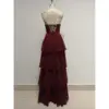 Back view of the Elizabeth Burgundy tiered chiffon ball gown showcasing the elegant lace-up corset back with delicate lace and rhinestone details, flowing into a multi-tiered chiffon skirt.