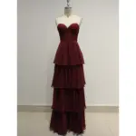 Stunning Elizabeth Burgundy tiered chiffon ball gown featuring a sweetheart neckline, intricate lace appliques with rhinestones on the bodice, and cascading layered chiffon skirt in rich burgundy hue.