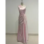Elegant Liora in Baby Pink Polyester Satin featuring a one-shoulder neckline with soft draping and ruched detailing that sculpts the figure in a sleek floor-length sheath silhouette.