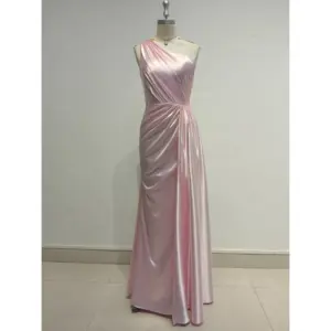 Elegant Liora in Baby Pink Polyester Satin featuring a one-shoulder neckline with soft draping and ruched detailing that sculpts the figure in a sleek floor-length sheath silhouette.