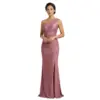 Elegant woman wearing a rich grape-colored one-shoulder jersey gown with draped asymmetrical neckline, ruched bodice and waist, and a high slit revealing the leg. The luxurious stretch jersey fabric creates a figure-flattering mermaid silhouette perfect for formal occasions.