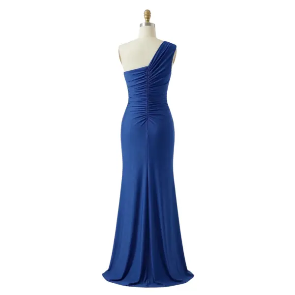 Back view of the Isabella royal blue jersey gown showcasing the one-shoulder design with elegant draping and ruching that continues into a fitted silhouette. Features a concealed back zipper closure, smooth jersey fabric, and a floor-length hem with a high slit for graceful movement.