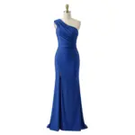 Elegant royal blue jersey one-shoulder gown on a mannequin featuring soft draped neckline, intricate ruching at the bodice and waist, and a figure-flattering sheath silhouette with a subtle high slit. The luxurious jersey fabric offers beautiful drape and movement.