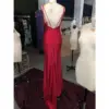 Detailed back view of Helena in Burgundy Jersey Sheath Dress highlighting the intricate criss-cross spaghetti straps, ruched lower back with soft pleating, and concealed zipper closure for a seamless finish