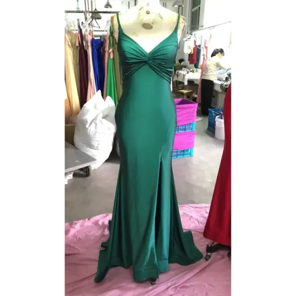Front view of Elena Teal Jersey Mermaid Dress featuring a plunging V-neckline with intricate ruched twist detail at the bust, figure-hugging silhouette, and dramatic front slit in luxurious teal fabric