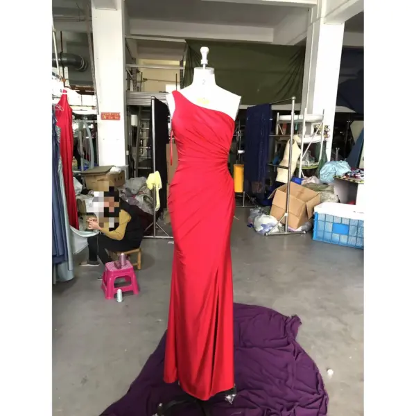 Stunning front view of the Giselle Jersey One-Shoulder Dress in vibrant red, featuring elegant one-shoulder neckline, intricate ruched detailing at the waist, and a figure-hugging sheath silhouette with a subtle side slit.