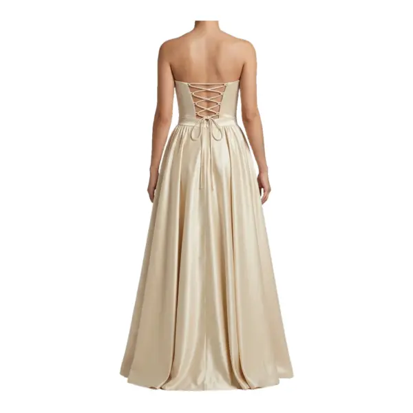 Back view of the Cécile Champagne Polyester Satin Ball Gown showcasing a dramatic lace-up corset back with criss-cross straps, natural waist tie, and flowing floor-length pleated skirt in shimmering champagne polyester satin.