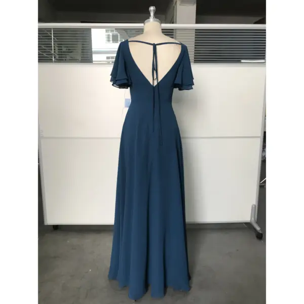 Back view of Clémence Dark Navy Chiffon Dress showcasing an open V-back with delicate tie detail, graceful flutter sleeves, and smooth flowing chiffon fabric.