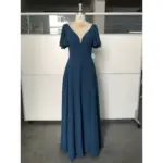 Clémence in rich Dark Navy flowing chiffon featuring a deep V-neckline, delicate flutter sleeves, and a graceful A-line silhouette that catches the light with every movement.
