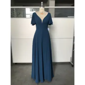 Clémence in rich Dark Navy flowing chiffon featuring a deep V-neckline, delicate flutter sleeves, and a graceful A-line silhouette that catches the light with every movement.