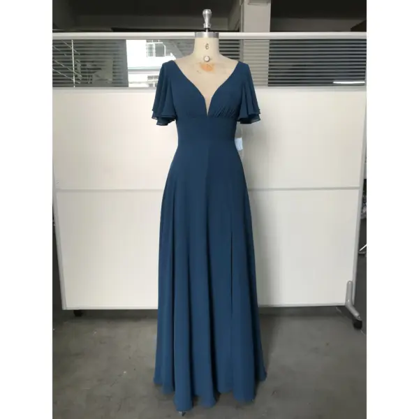 Clémence in rich Dark Navy flowing chiffon featuring a deep V-neckline, delicate flutter sleeves, and a graceful A-line silhouette that catches the light with every movement.
