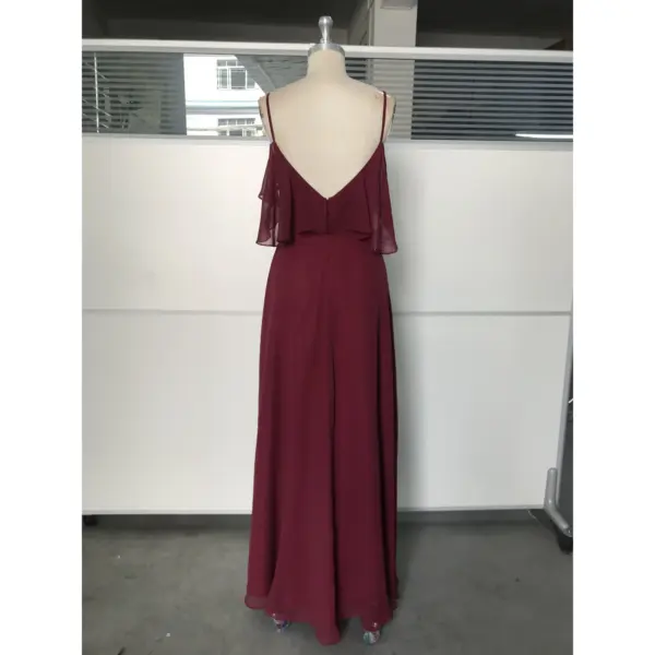 Back view of the Capucine Wine Chiffon gown showcasing a flattering V-back with delicate straps, cascading ruffle detail on the shoulders, and a smooth A-line silhouette in luxurious flowing Chiffon.