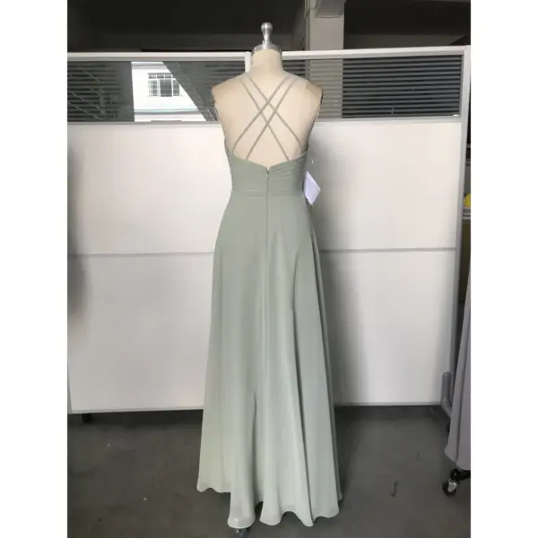 Back view of the Simone Sage Green Chiffon Halter A-Line Gown showcasing an elegant criss-cross strap design, ruched waistband, concealed zipper, and graceful floor-length A-line silhouette in soft sage green chiffon.