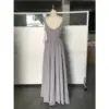 Back view of the Jolanda Silver Chiffon gown showcasing a deep V-back, concealed zipper closure, and softly pleated waist detail that transitions into a graceful floor-length A-line skirt in shimmering silver chiffon.