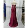 Back view of Alex Burgundy stretch satin mermaid gown showcasing dramatic lace-up corset back with intricate criss-cross detailing, ruched hips, and sweeping train